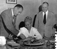 Evita with her brother Juan Duarte and Raul Apold